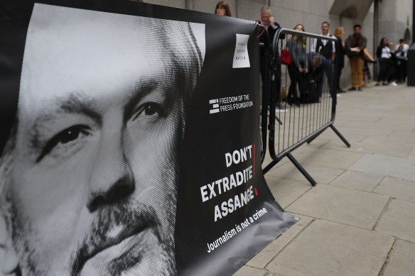 People queue at the entrance of the Old Bailey court in London during Julian Assange's extradition hearing.