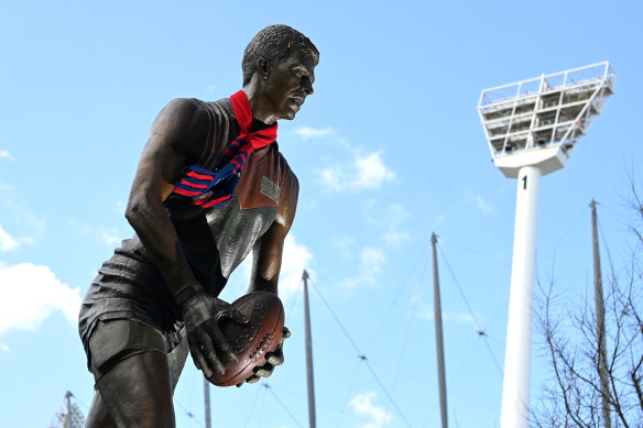 A Demons scarf adorns the statue of Jim Stynes outside the MCG. 