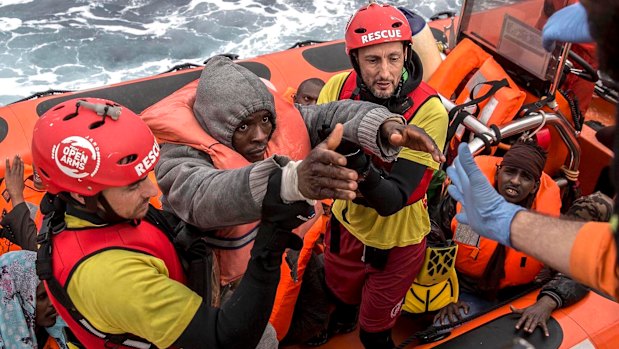 Refugees and migrants are transferred to a rescue ship by aid workers of the Spanish NGO Proactiva Open Arms, in February.