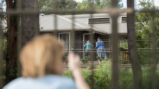 Mary Watson waves to her mother Alice Bacon, 93, who currently has coronavirus at Newmarch House. 
