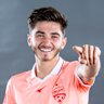 ADELAIDE, AUSTRALIA - NOVEMBER 15: Josh Cavallo poses in their coral strip during the Adelaide United A-League headshots session at Adelaide Entertainment Centre on November 15, 2021 in Adelaide, Australia. (Photo by Mark Brake/Getty Images for APL)