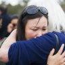 Jangchu Wangchuk is hugged by a supporter at the rally outside Parliament House on Friday.