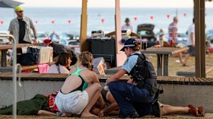 A police officer and member of the public help a victim.