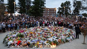Mourners at a vigil at Bondi Pavilion on Monday.