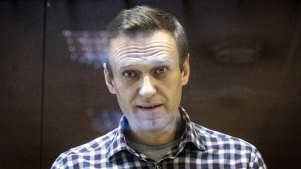 Russian opposition leader Alexei Navalny looks through a glass cage during a court appearance in 2021.