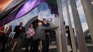 Premier Daniel Andrews and Victorian Pride Centre chair Hang Vo raise the flag at the centre in St Kilda on Sunday.