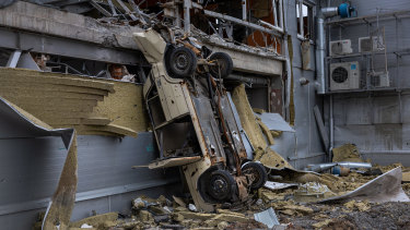 A vehicle stands upended in a former frontline neighborhood on May 21, 2022 in Kharkiv, Ukraine, where Russian forces have been targeting residential areas.