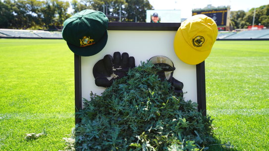 Rod Marsh’s Baggy Green cap and wicketkeeping gloves and sprigs of wattle.