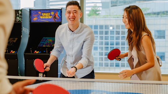 Employees in the Singapore office of Salesforce take a break for a game of ping pong.
