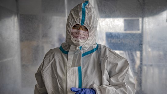 A Chinese traveler wearing a protective suit passes through a decontamination tent upon arriving at Ninoy Aquino International Airport in Manila, Philippines.