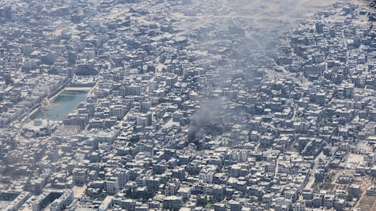 Smoke rises from Gaza City, as seen from a Jordanian Air Force C-130 plane during an airdrop of humanitarian aid for Palestinians on Thursday.