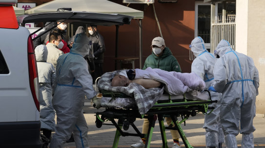 An elderly man is taken into the fever clinic at a hospital in Beijing on Friday.