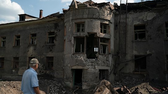 A man stands in front of a heavily damaged building of a regional sports school after a Russian attack in Druzhkivka, Donetsk region, eastern Ukraine.