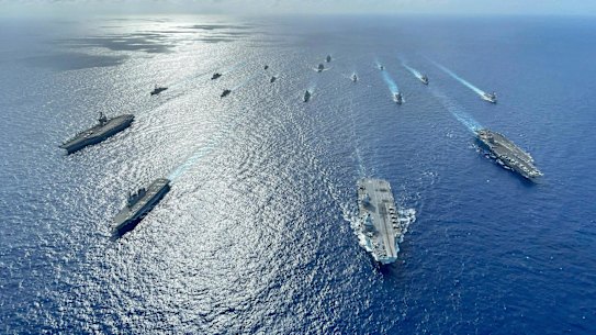 Japanese destroyers with US and British carriers pictured during operations in the Philippine Sea in 2021.
