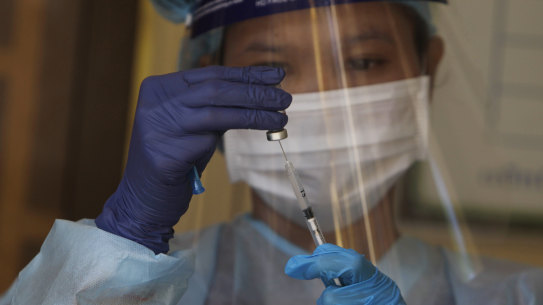 A health worker prepares a dose of the Sinovac’s COVID-19 vaccine. 