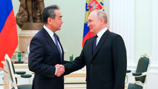 Russian President Vladimir Putin greets Chinese Communist Party’s foreign policy chief Wang Yi.