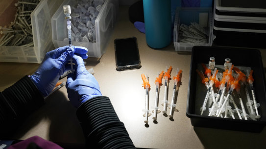 A registered nurse fills syringes with Pfizer vaccines at a COVID-19 vaccination clinic. The latest alarming coronavirus variant, the delta variant, is exploiting low global vaccination rates and a rush to ease pandemic restrictions, adding new urgency to the drive to get more shots in arms and slow its supercharged spread.