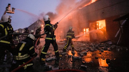 Ukrainian firefighters extinguish a blaze at a warehouse after a bombing in Kyiv on Thursday.