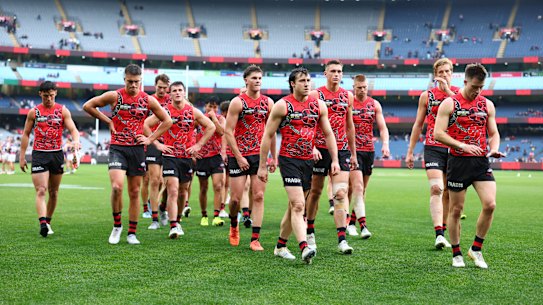 The Bombers trudge off the ground after their demoralising loss to the Dockers.