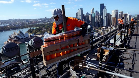 Workers are spaced five to ten metres apart to pass equipment in a “production line”.