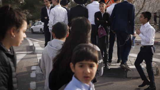 People visit the place where seven Israelis were killed in a shooting attack in East Jerusalem. 