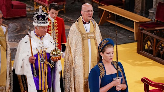Lord President of the Council Penny Mordaunt holds the Sword of State walking ahead of King Charles III during his coronation ceremony.