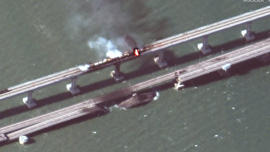 This satellite image provided by Maxar Technologies shows damage to the Kerch Bridge, which connects the Crimean Peninsula with Russia crossing a strait between the Black Sea and the Sea of Azov.