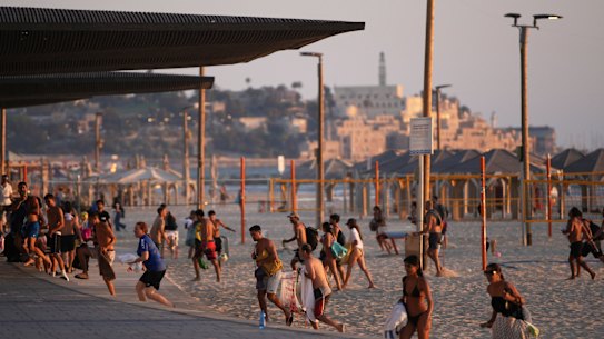 Beachgoers in Tel Aviv leave during a missile alert from Iran.