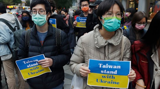 Protestors display placards in Taipei .