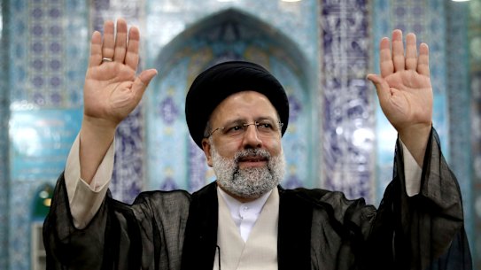 Ebrahim Raisi, Iran’s new President, waves to media after casting his ballot in Tehran on Friday. 