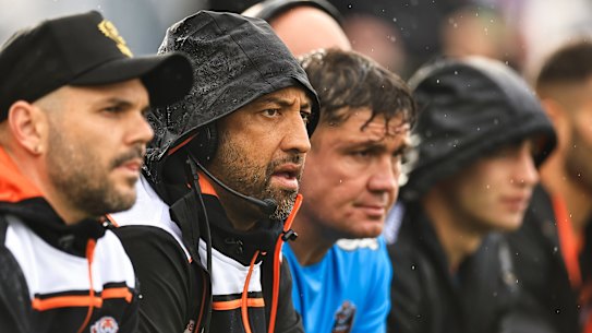Wests Tigers coach Benji Marshall (second from left) on the bench in Tamworth.