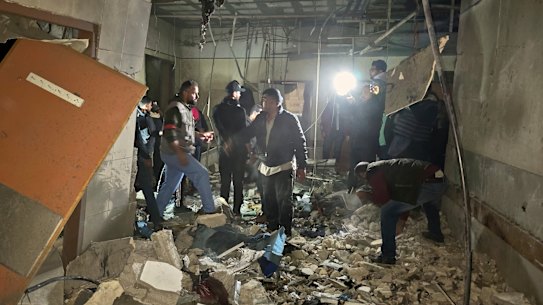 Rescue workers inspect a room at Nasser hospital after it was hit by a targeted Israeli army strike in Khan Younis on Sunday