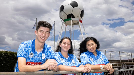 Marconi Stallions supporters Kobe Anderson, Sofia Keith, and Aileen Anderson, in front of the famous (and freshly repainted) giant ball at the stadium.