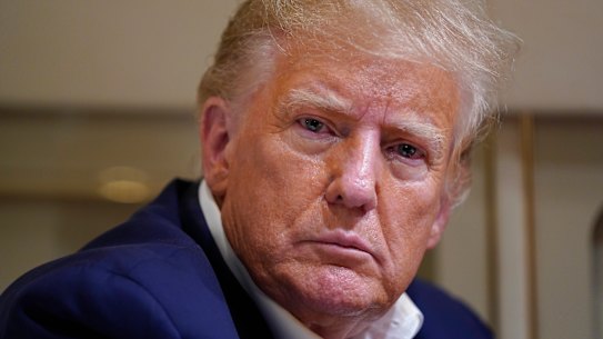 Former President Donald Trump listens as he speaks with reporters while in flight on his plane after a campaign rally last weekend.