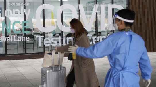 A woman arriving from China enters a COVID-19 testing centre at the Incheon International Airport In Incheon, South Korea.