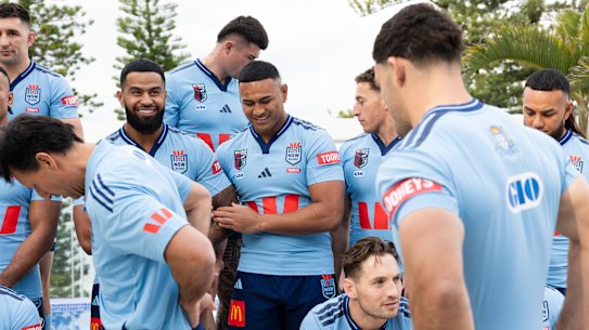 Watch your back: Blues stars come to the defense of coach Laurie Daley.
