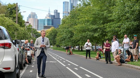 Auctioneer Charles Atkins looks to the crowd, as bids inch up in increments of $1000.