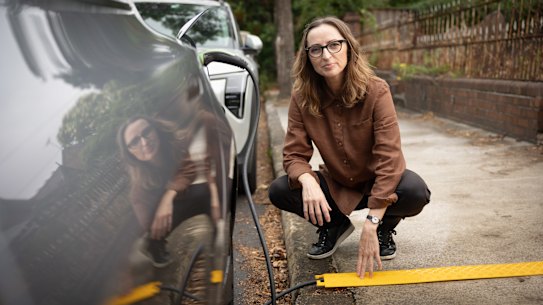Electrification and EV advocate Sarah Aubrey with her authorized cable cover.