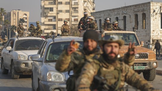 Syrian opposition fighters ride along the streets in the aftermath of the opposition’s takeover of Hama, Syria, on Friday.