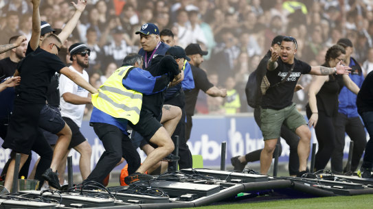 Fans storm the field on Saturday.