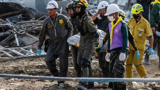 Thai rescue workers remove a body recovered from the building that collapsed in Bangkok’s Chatuchak area.