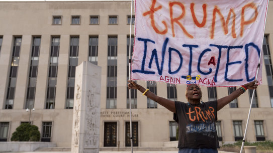 Nadine Seiler protest as she holds a banner outside federal court in April last year.