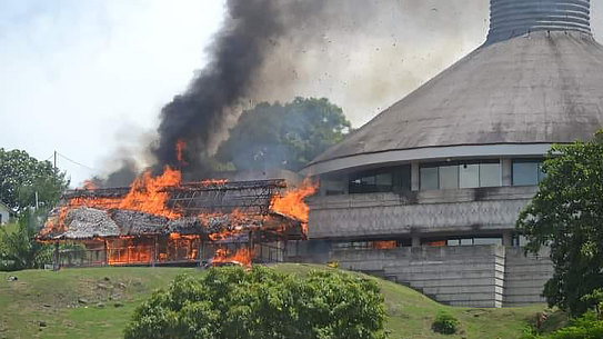 A building burns next to the Parliament building in Honiara on Solomon Islands on Wednesday.