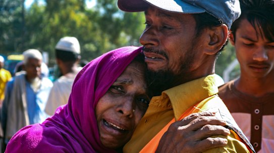 'They are taking us forcefully': a Rohingya man comforts a refugee woman as they are relocated to Bhasan Char. 
