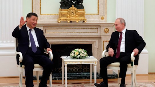 Chinese President Xi Jinping gestures while speaking to Russian President Vladimir Putin during their meeting at the Kremlin on Monday.