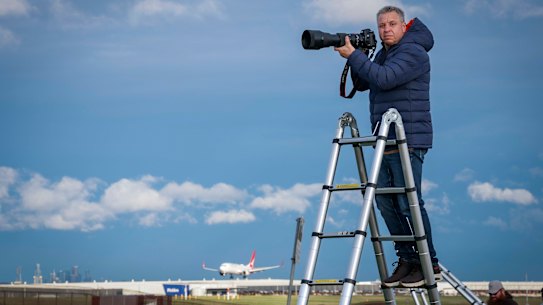 Plane spotter Kevin Alexopoulos is ready to take a dramatic photo on his new staircase near Melbourne's Tullamarine Airport.