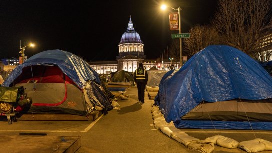 San Francisco’s homeless rest in the shaows of city hall.