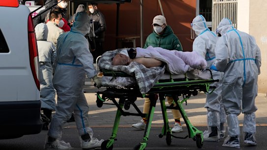 An elderly man is taken into the fever clinic at a hospital in Beijing on Friday.