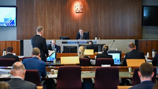 Commissioner Stuart Wood listens to senior assisting counsel, Patrick Wheelahan, during a hearing in February.
