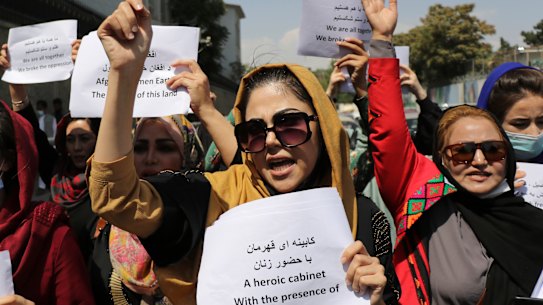 Women gather to demand their rights under the Taliban rule during a protest in Kabul on Friday